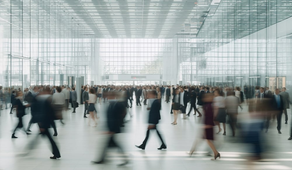 A crowd of people in motion in a large indoor public space.