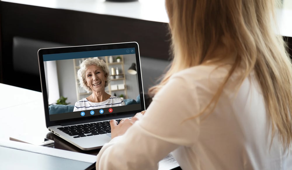 Daughter on computer video chatting with Mother