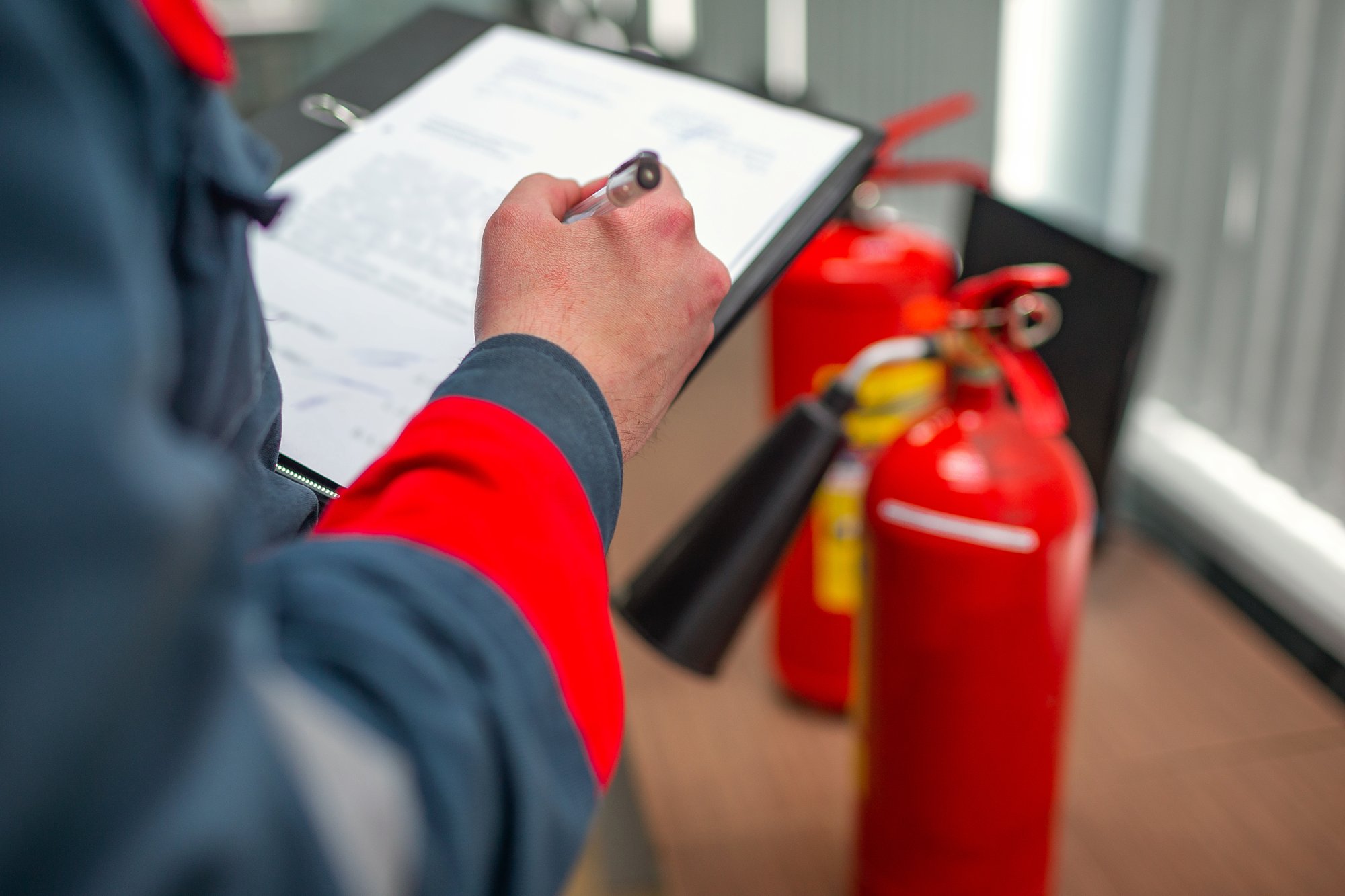 Fire inspector taking notes on clipboard