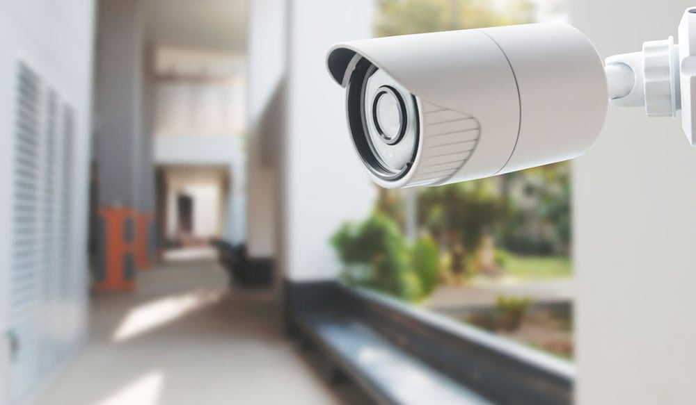 Close up of a home security camera in the outside walkway of a residential home