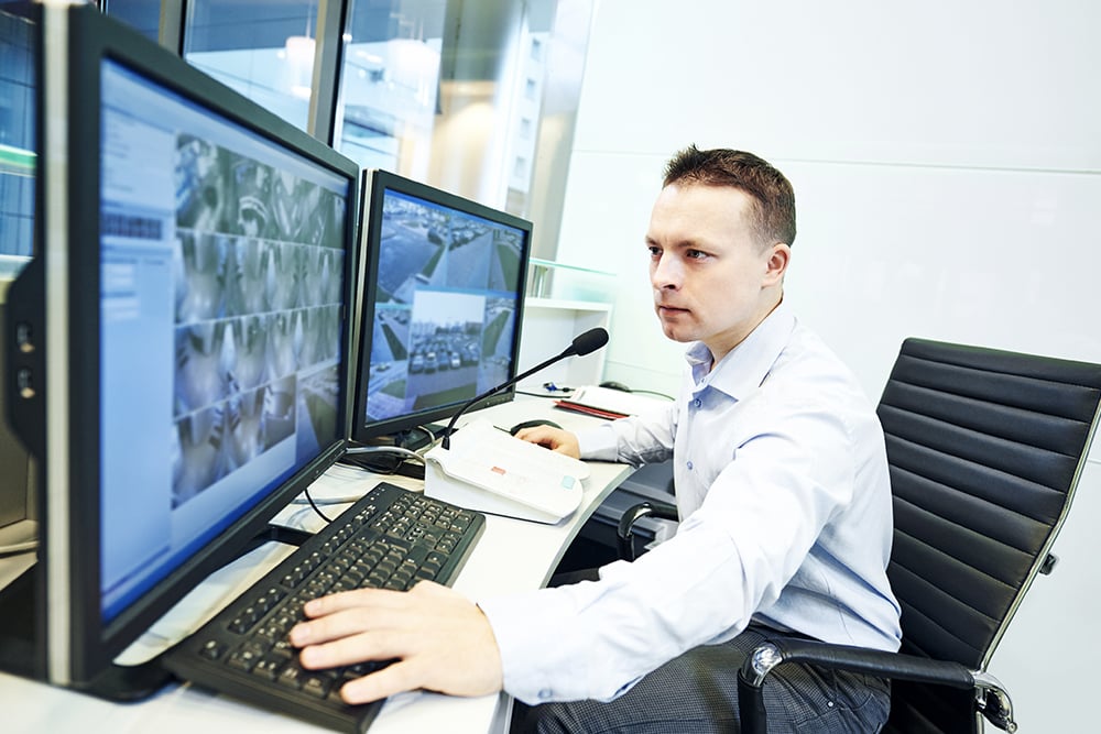 Security monitor looking intensely at monitors